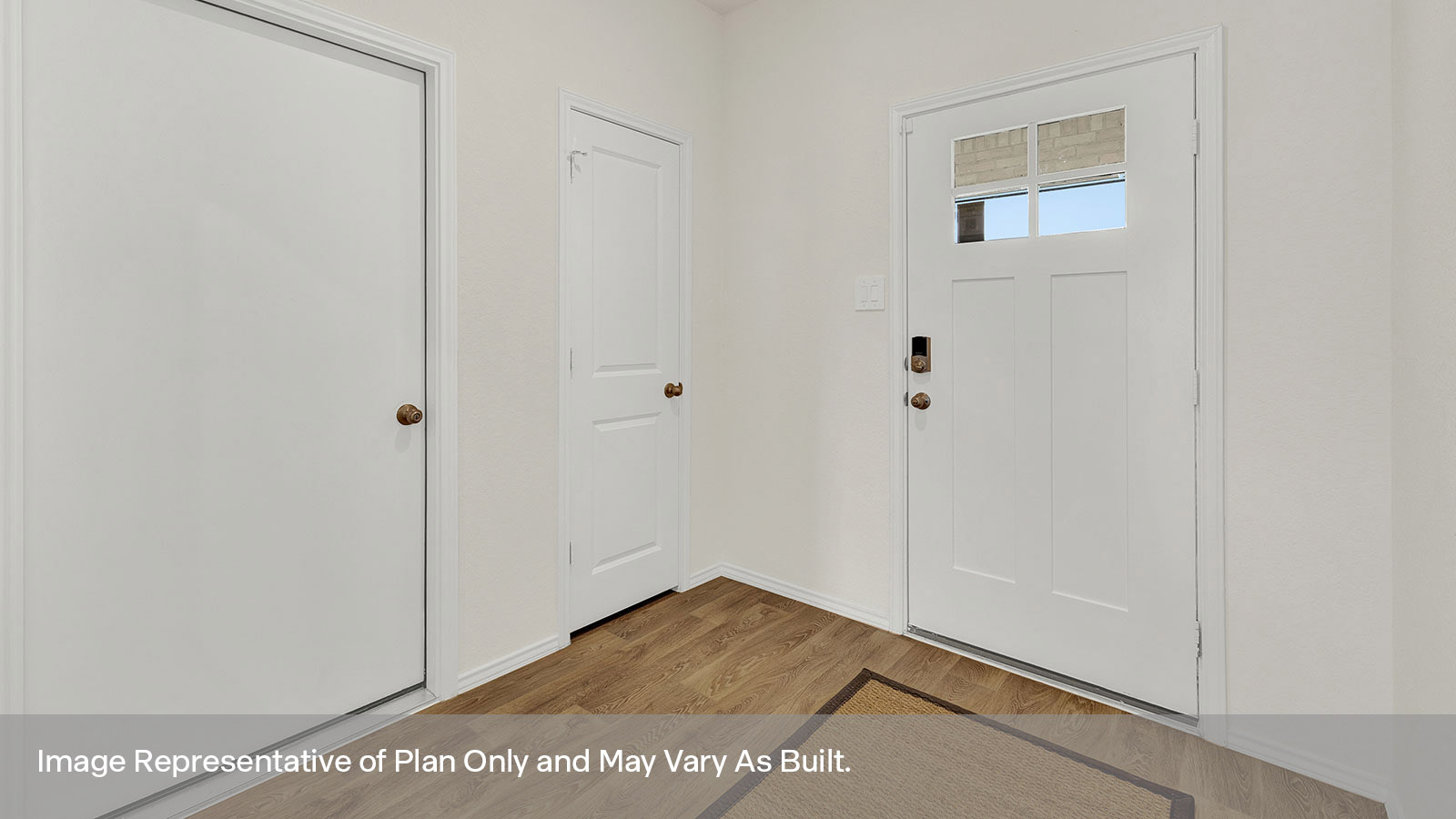 Entry hallway with vinyl flooring and front door.