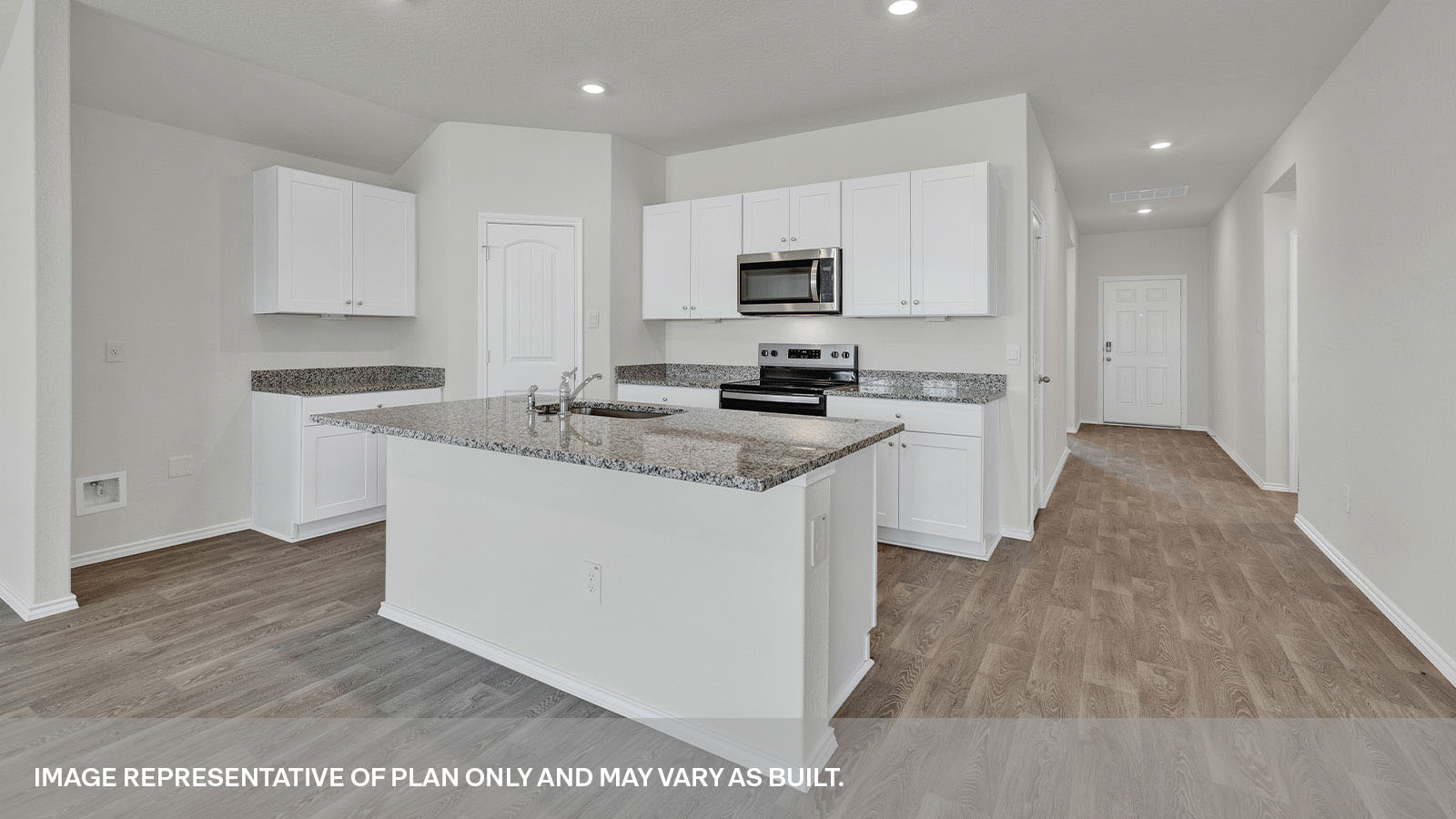 Kitchen with a kitchen island and front entry.