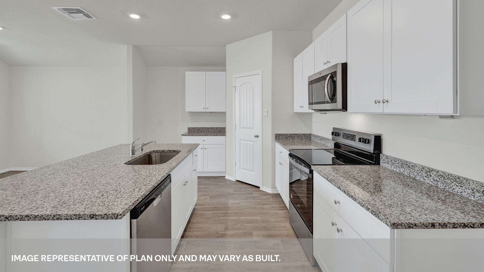 Kitchen with a kitchen island and large sink and appliances.