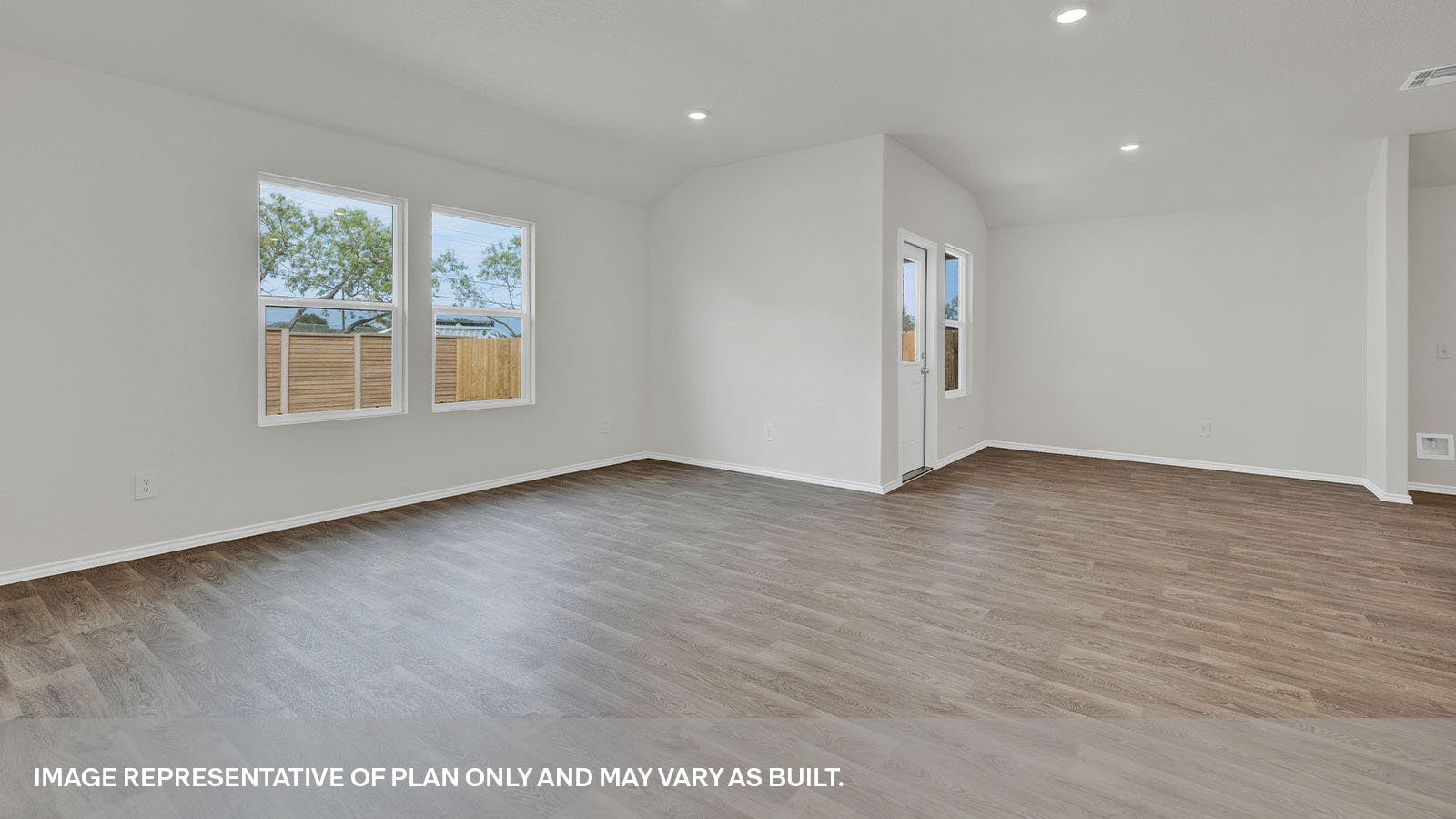 Living room and dining area a backdoor with a half-lite window.