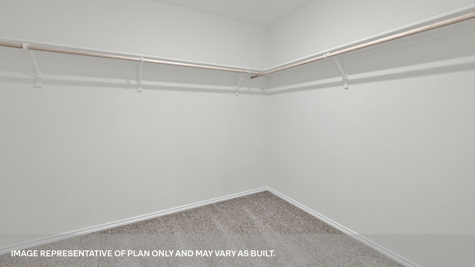 Walk-in closet with wooden shelves.