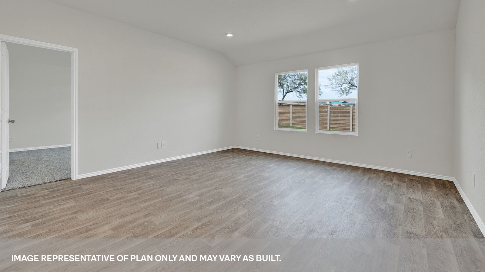 Living room with vinyl flooring and two windows.