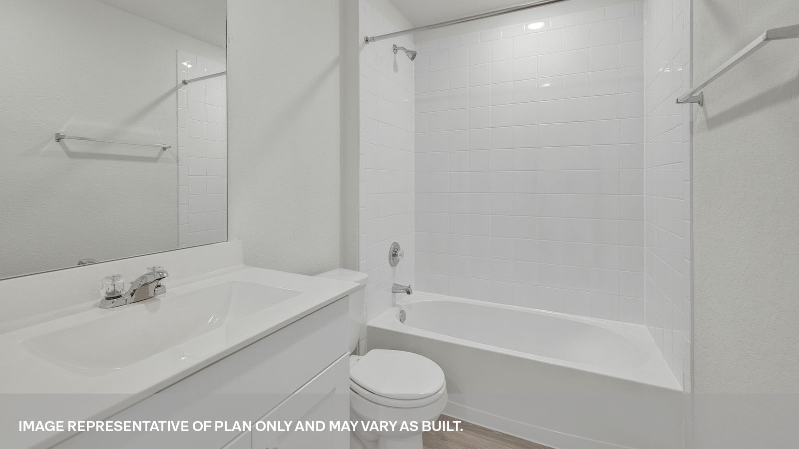 Hall bathroom with single sink vanity, toilet, and tub with tile surround.