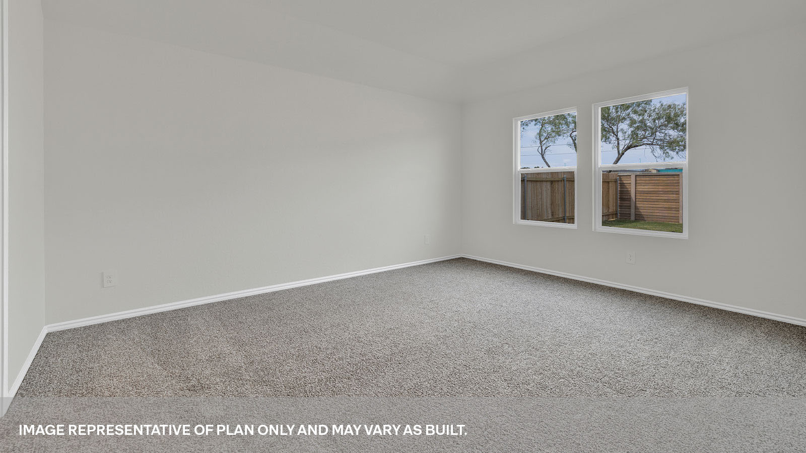 Main bedroom with carpet and two windows.