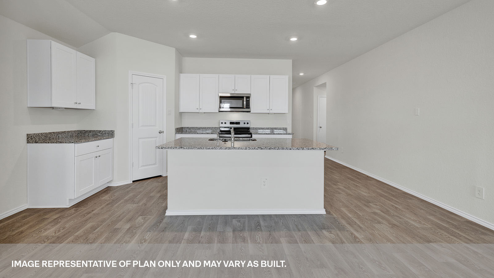 Kitchen with a kitchen island and front entry.