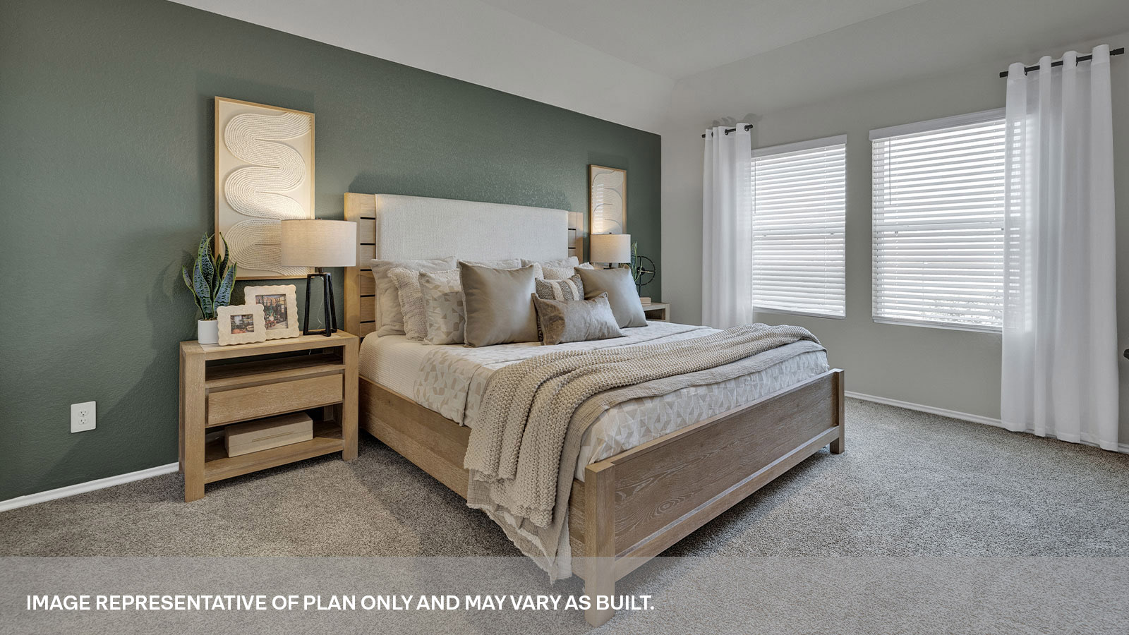 Main bedroom with carpet and two windows.