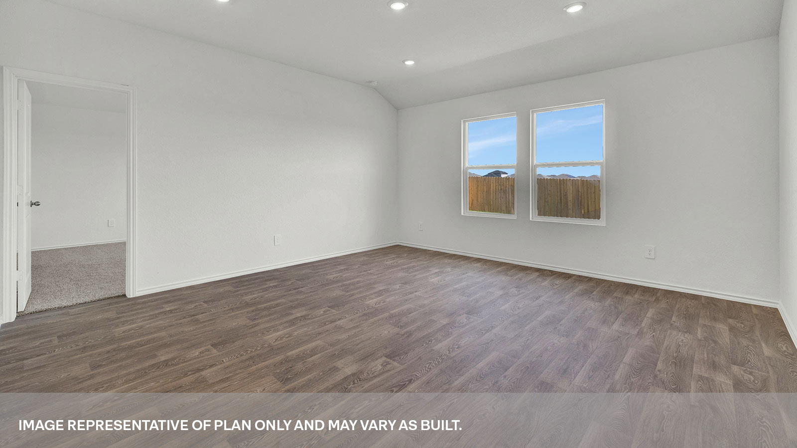 Living room with vinyl flooring and two widnows.