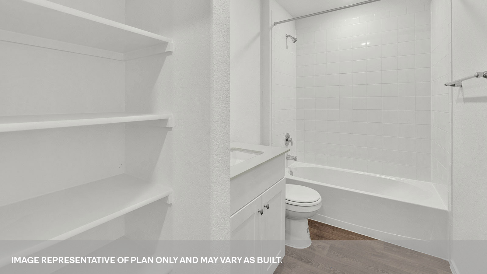 Bathroom with a tile surround shower/tub combo, single sink, wood shelf and white cabinets.