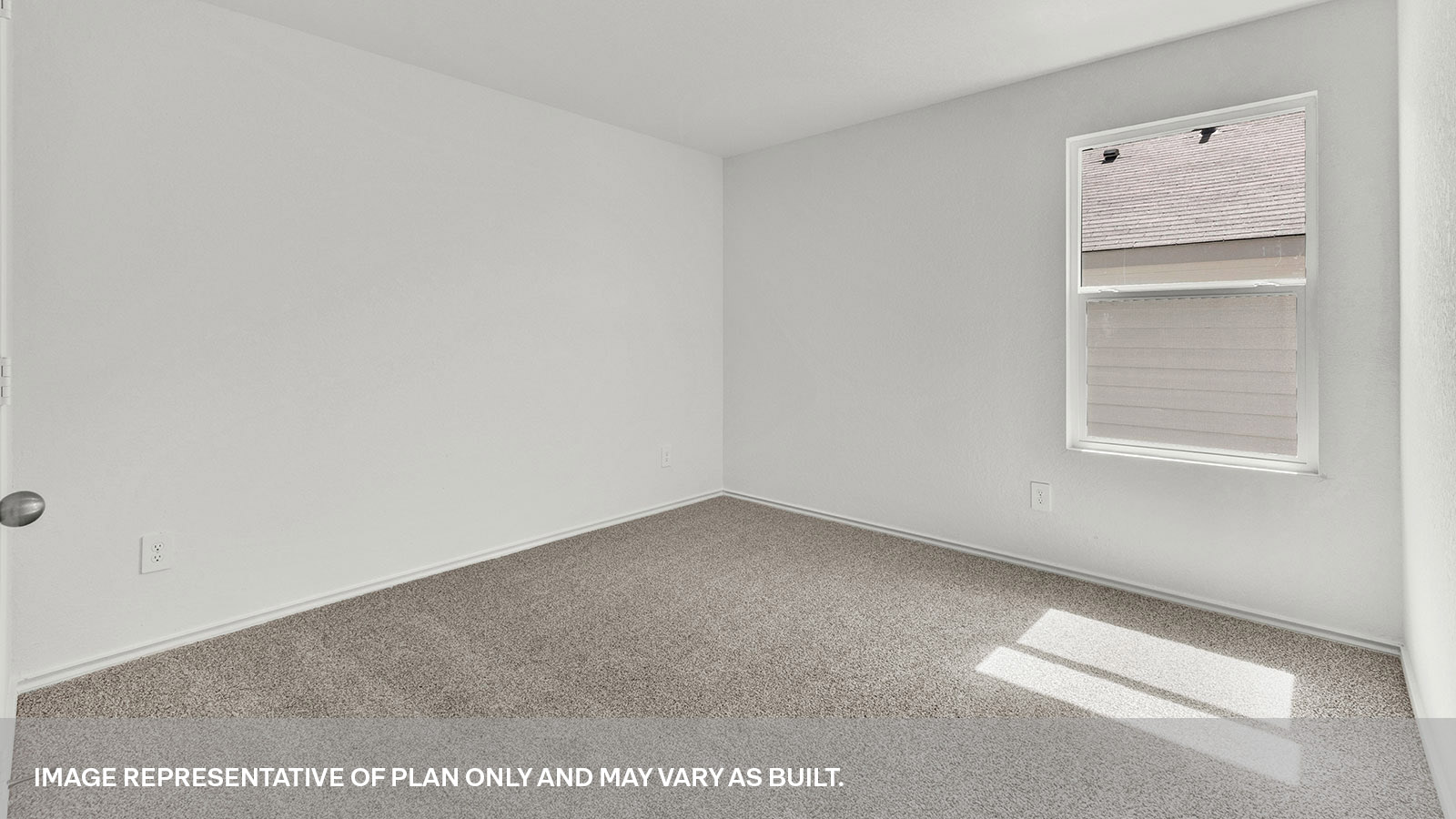Second bedroom with carpeting and a window showing the side yard.