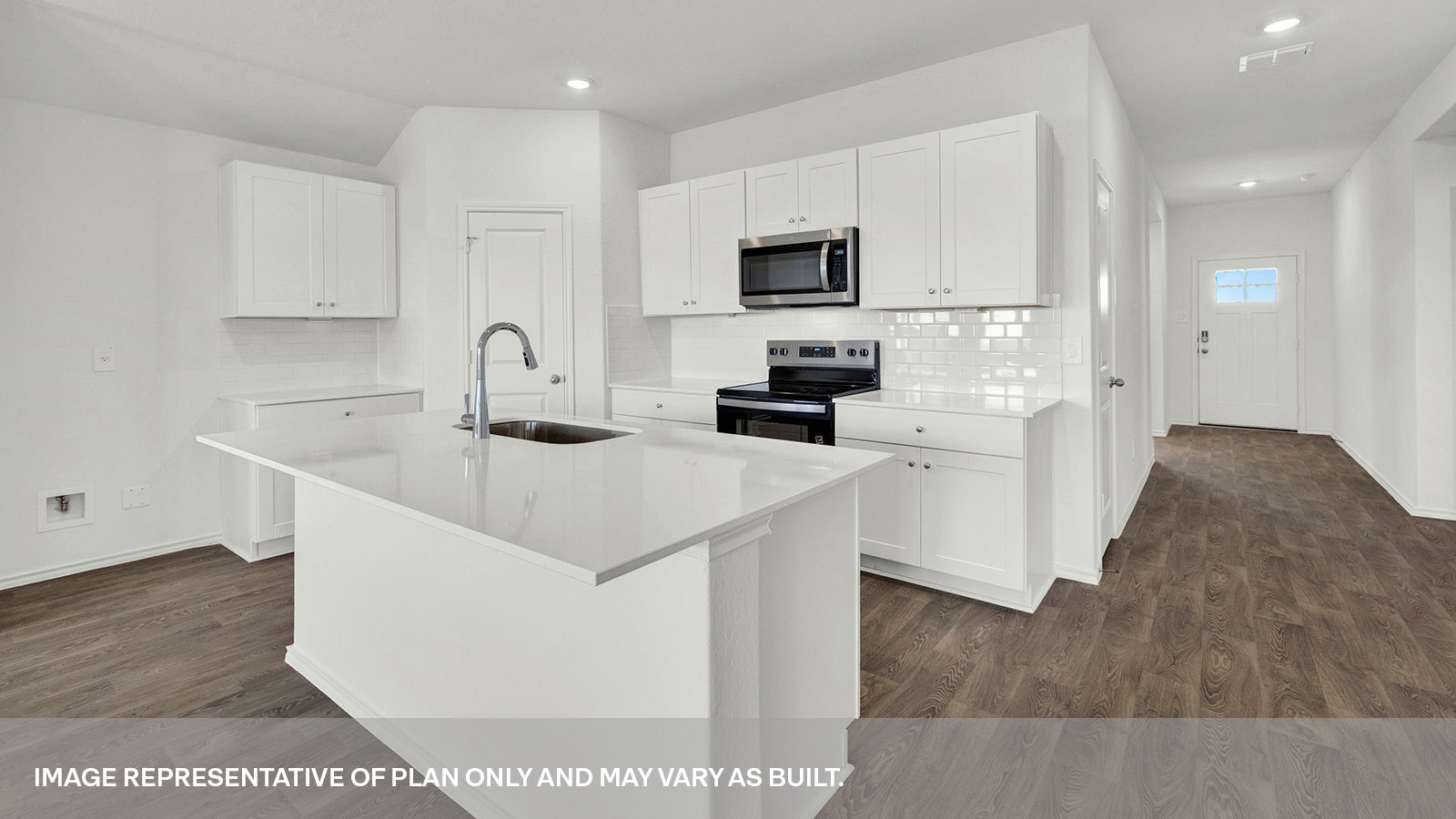 Entry hallway leading to the kitchen with kitchen island.