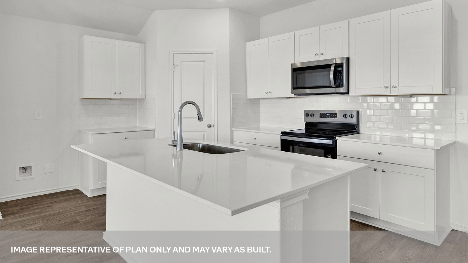 Kitchen with quartz countertops and stainless steel appliances.