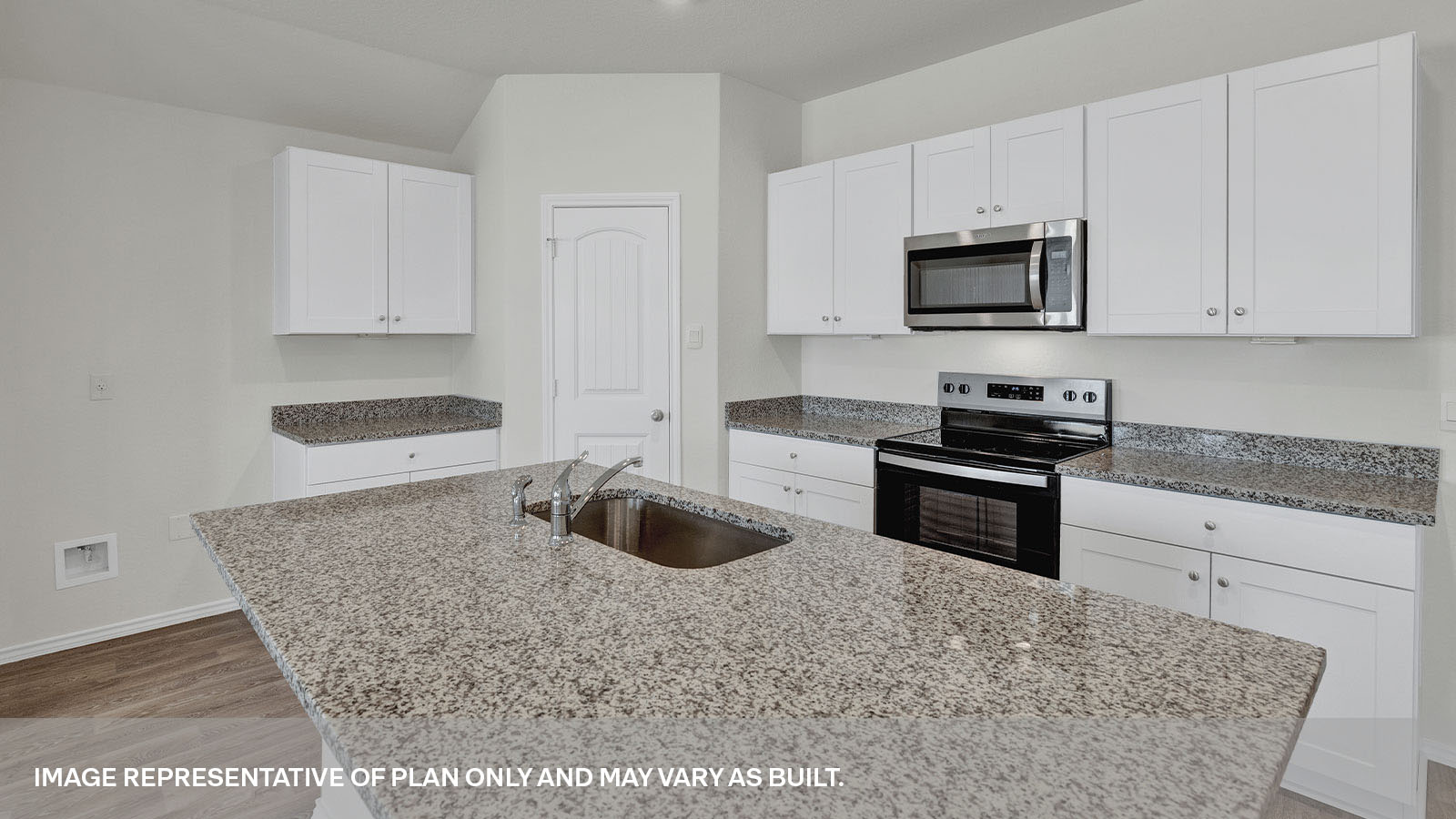Kitchen with a kitchen island and large sink and appliances.