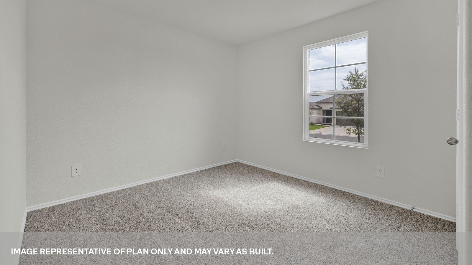 Front bedroom with carpeting and a window showing the front yard.