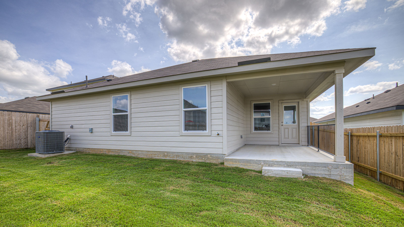Covered back patio with privacy fence.