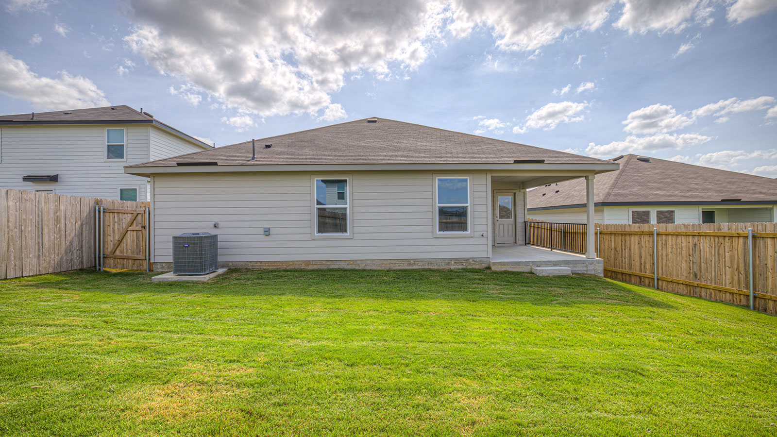 Covered back patio with privacy fence.