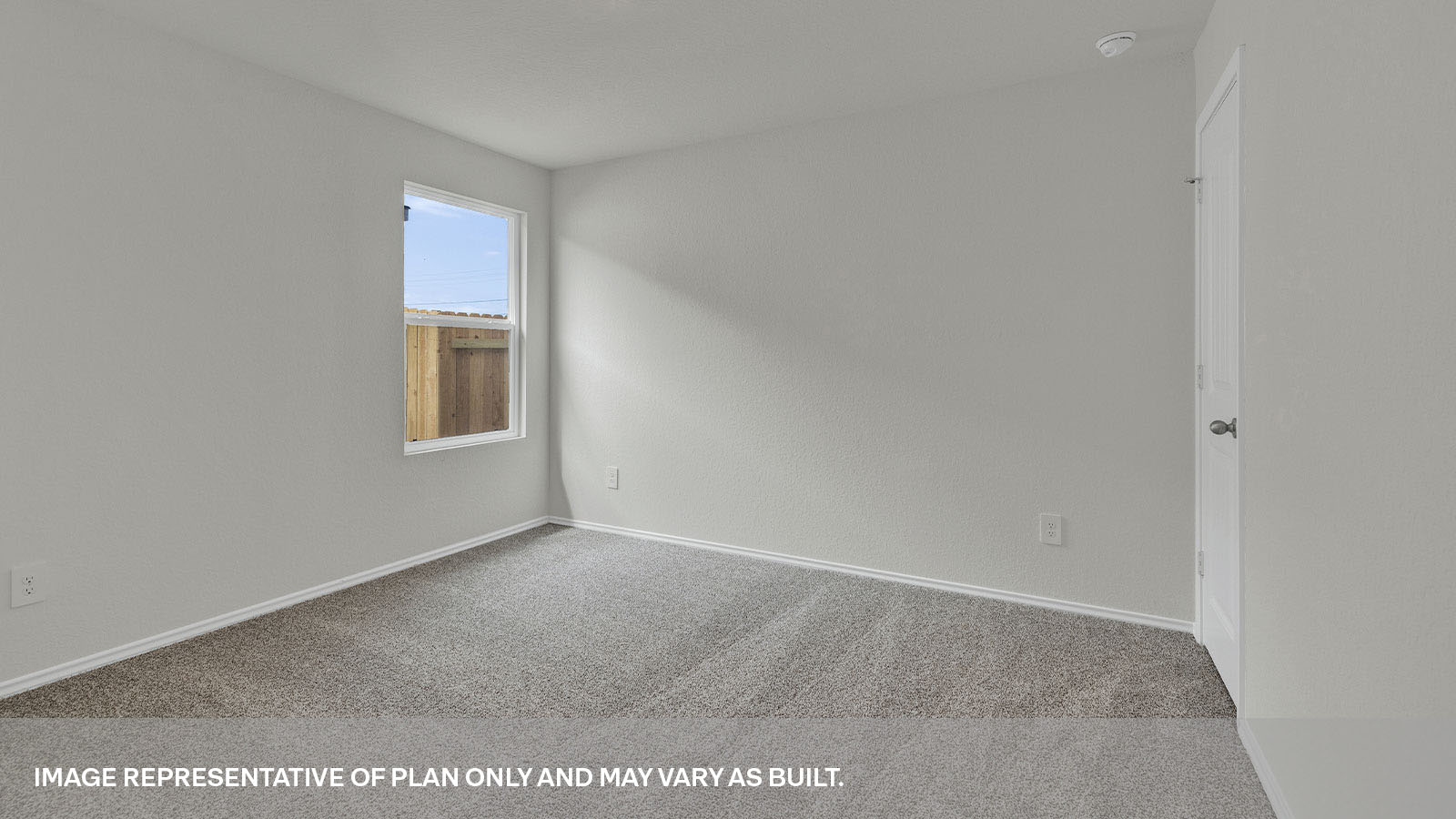 Bedroom with carpeting and one window.