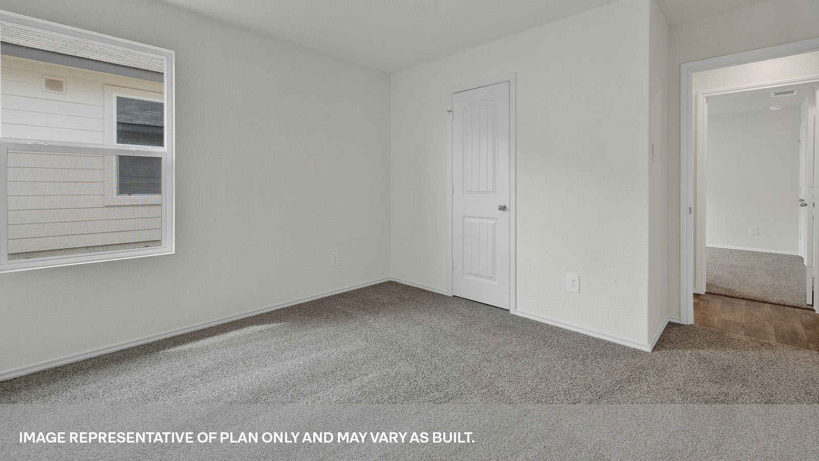 Bedroom with carpeting and one window.