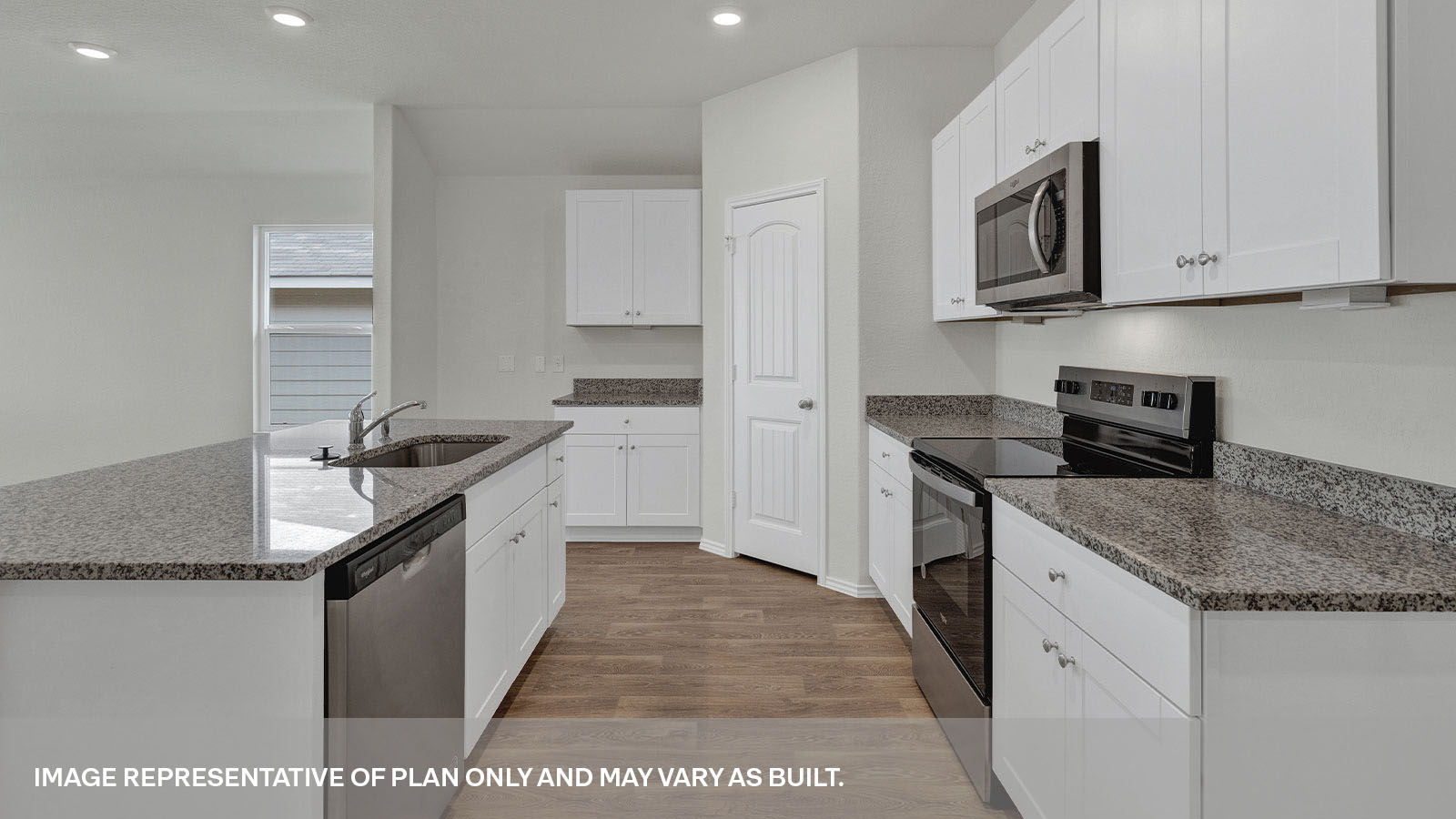 Kitchen with kitchen island and white cabinets.