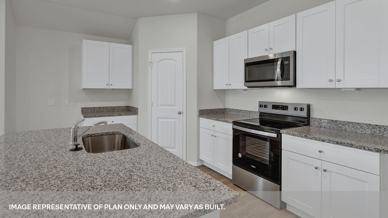 Kitchen with kitchen island and white cabinets.