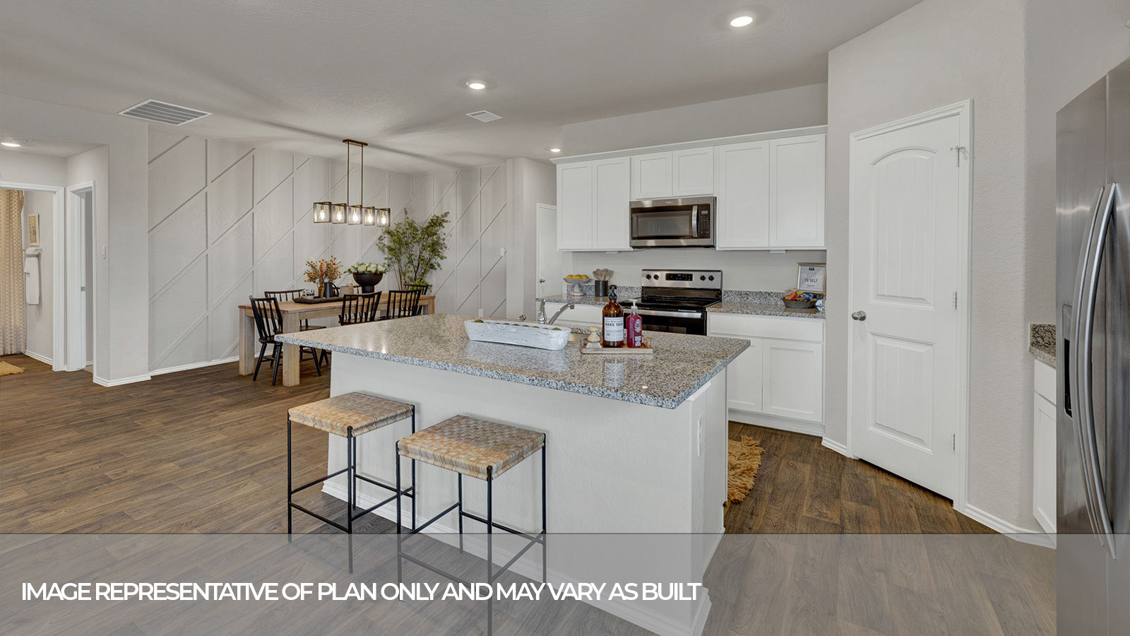 Kitchen with a kitchen island and large sink and appliances.