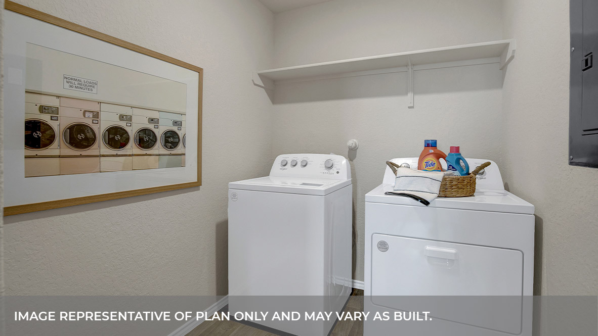 Laundry room with a wood shelf and washer/dryer connections.