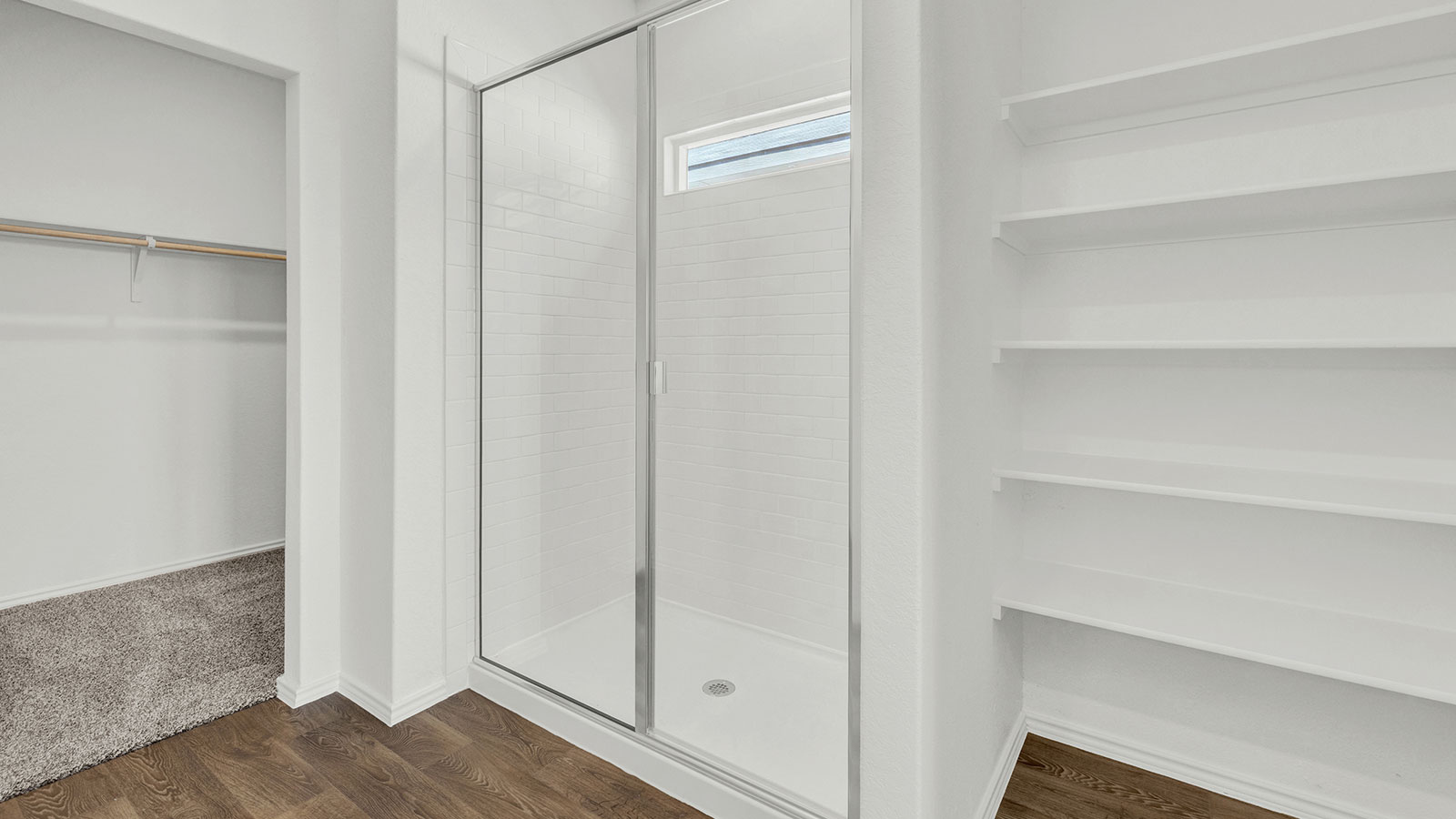 Main bathroom with stand in shower and wooden shelving.