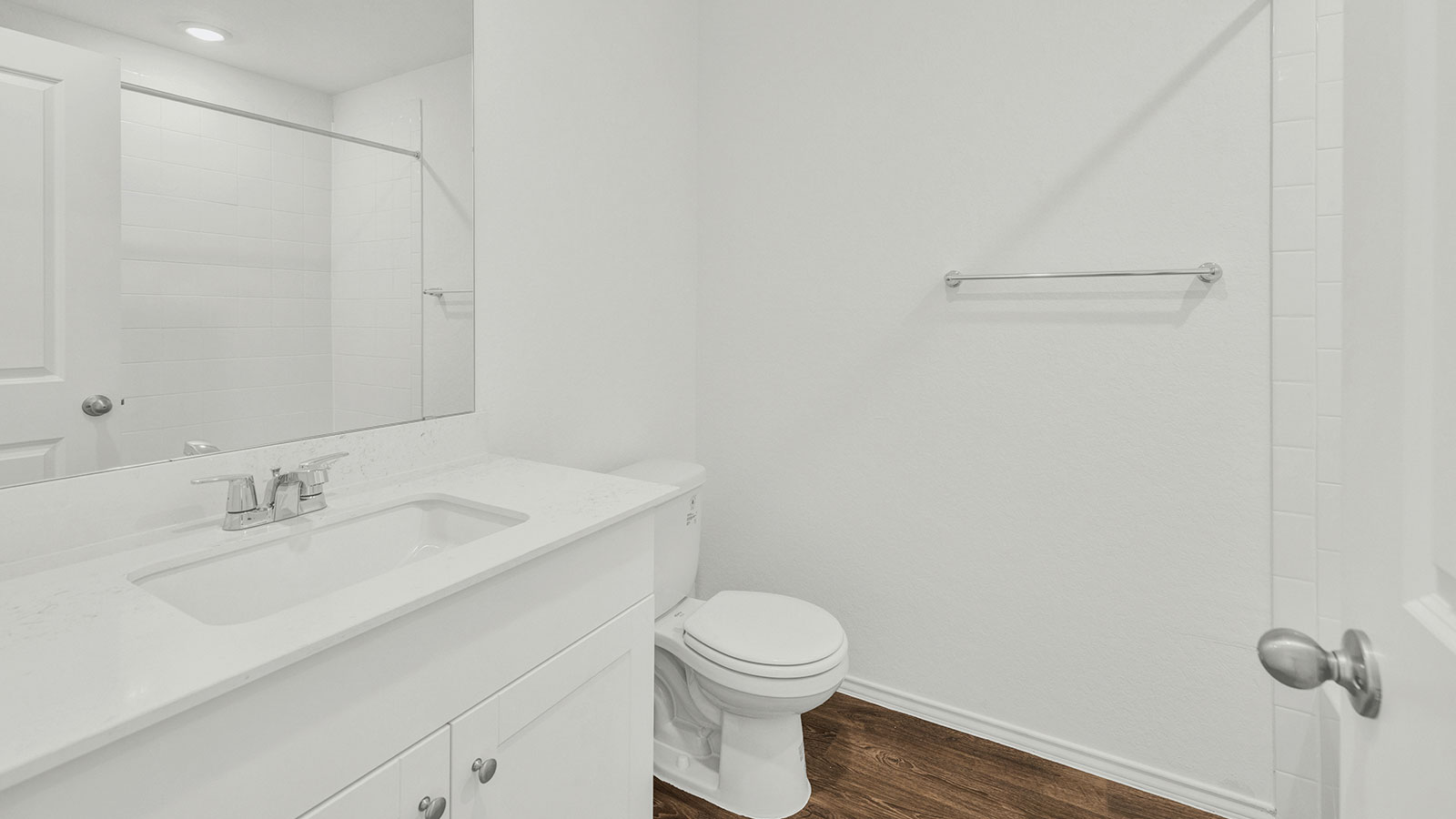 Hall bathroom with vanity and toilet.