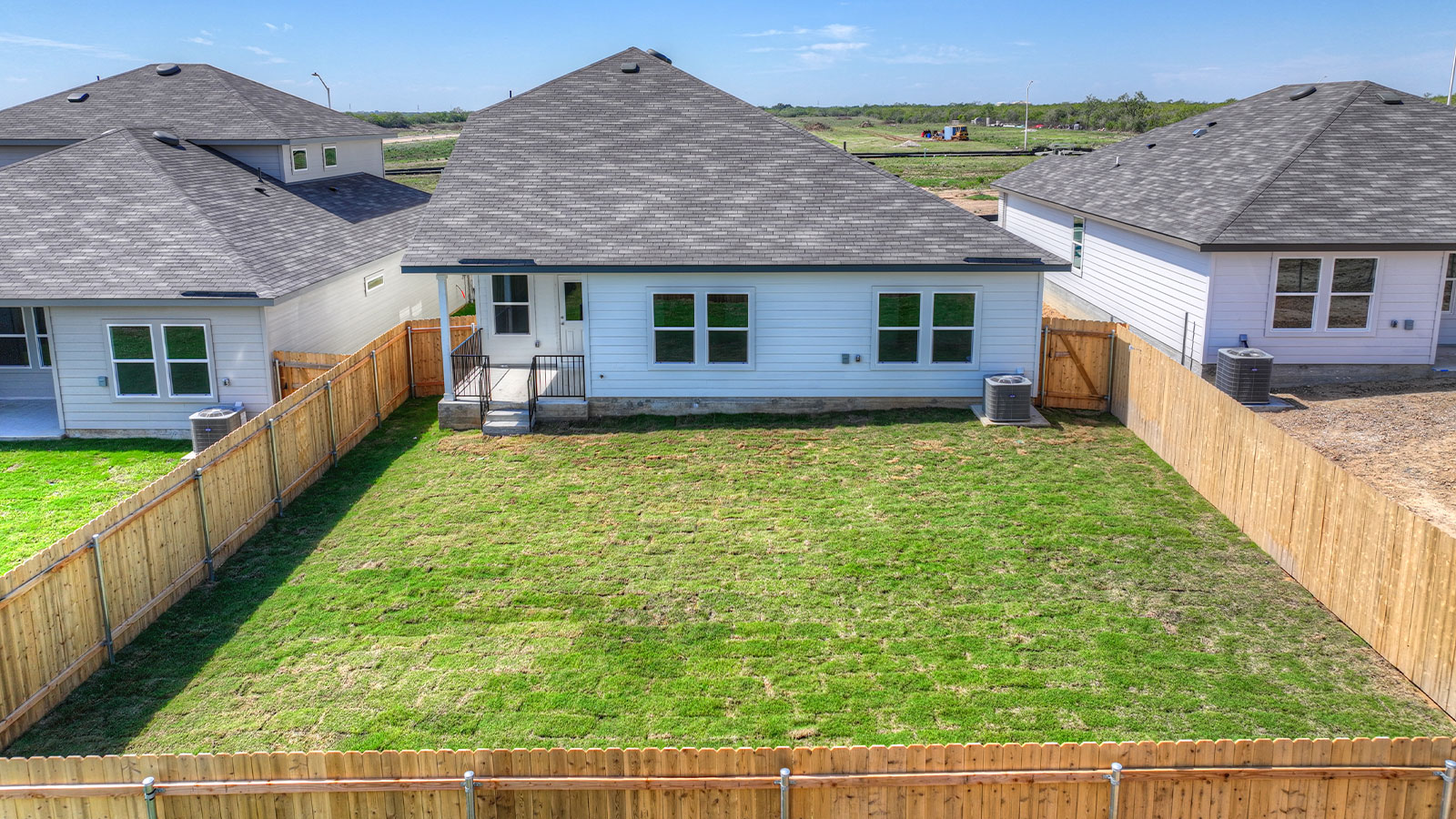 Backyard with sod and privacy fence.