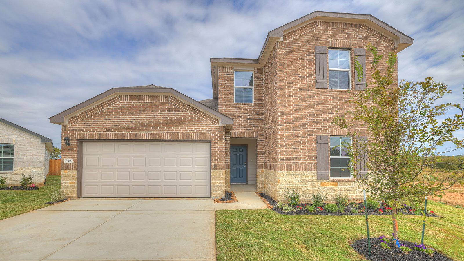 Midland Elevation B, two story with brick exterior, 3 front windows, and 2 car garage.