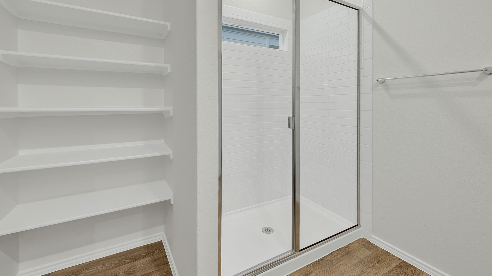 Main bathroom with walk-in shower and wooden shelving.