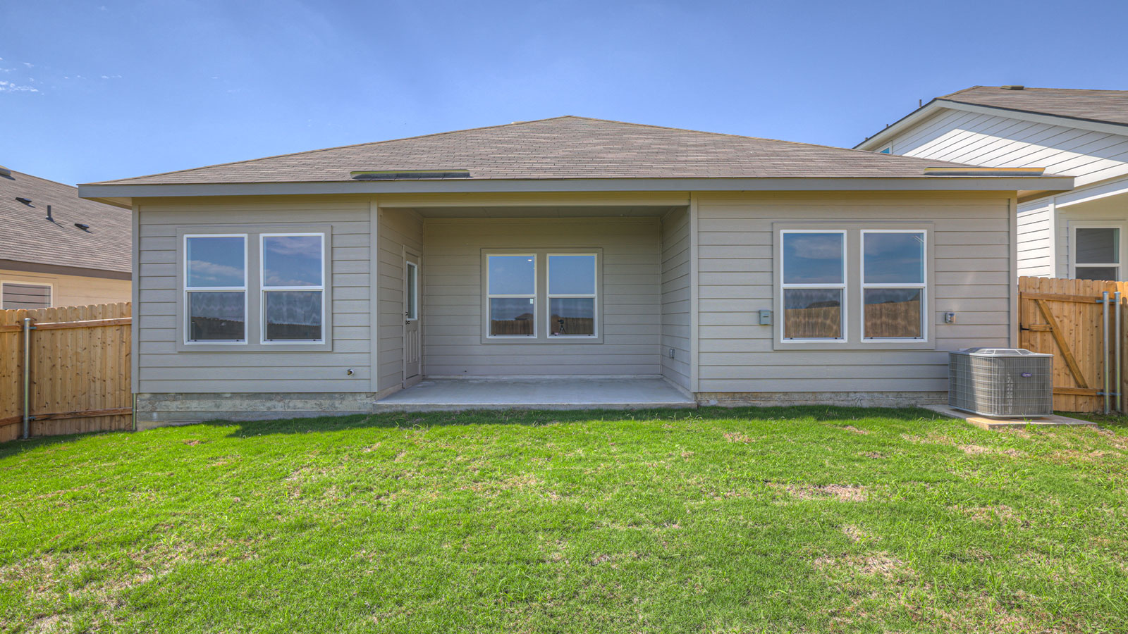 Covered patio with fully sodded backyard and privacy fence.