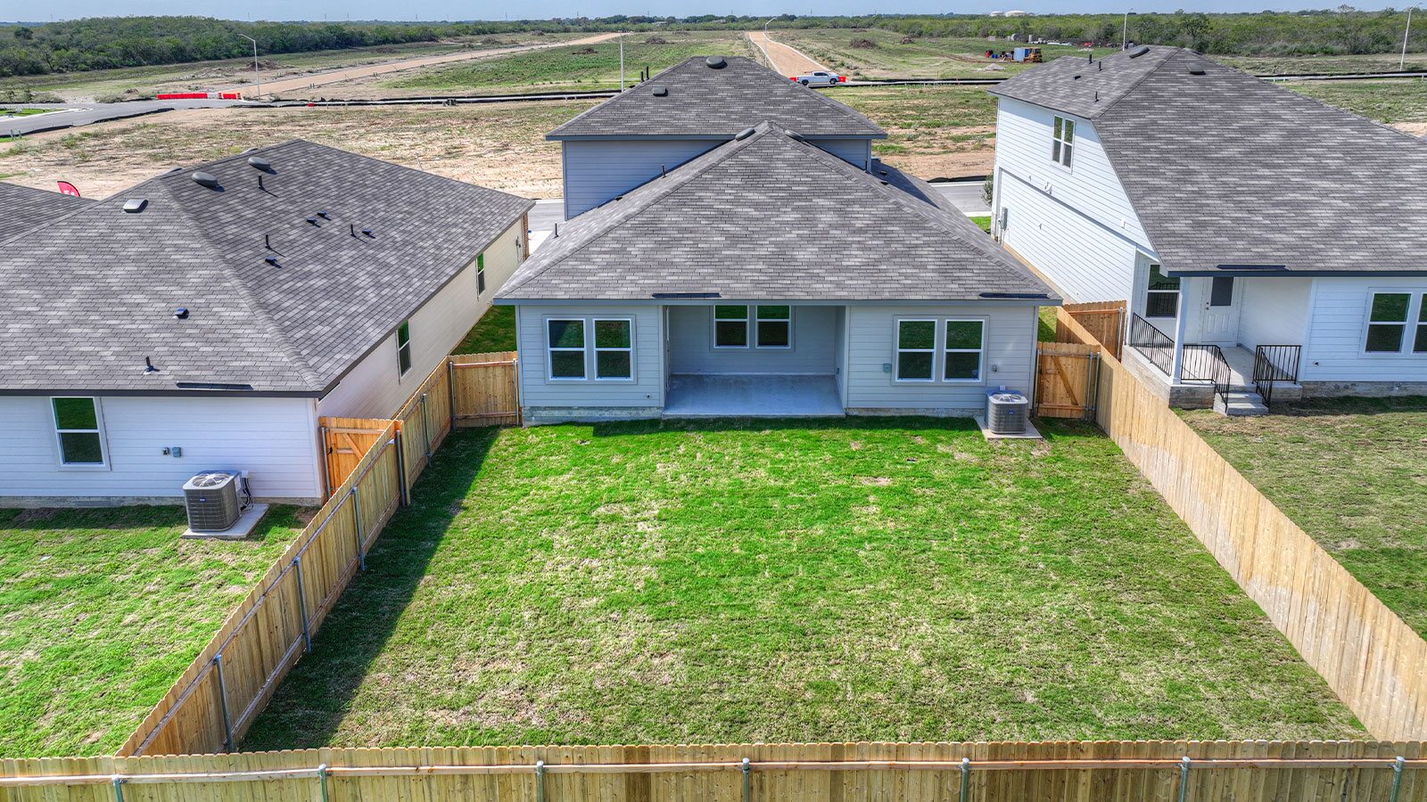 Backyard with sod and privacy fence.
