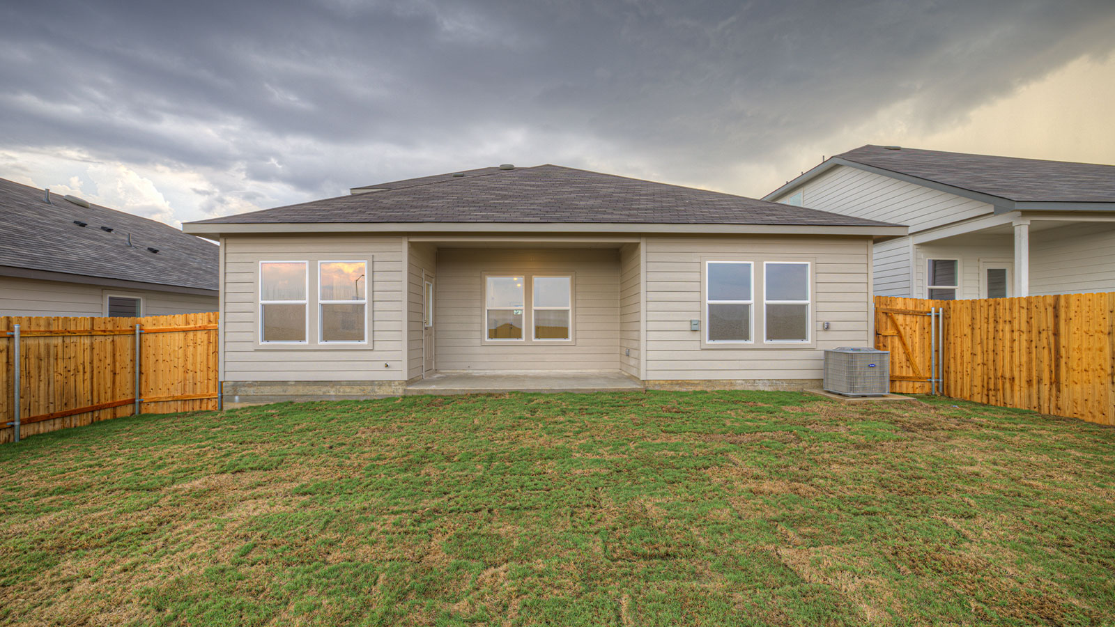 Covered patio with fully sodded backyard and privacy fence.