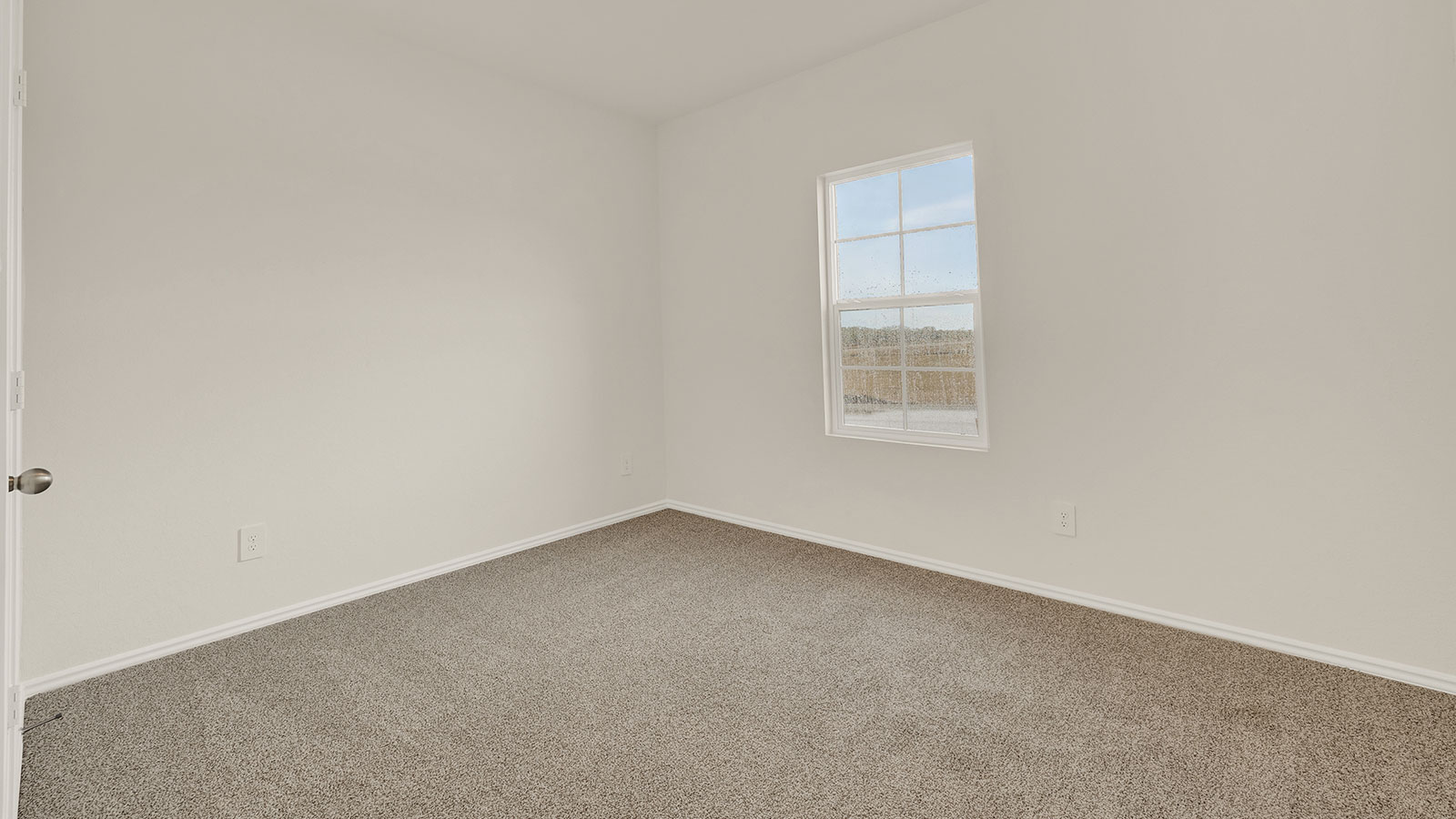 Front bedroom with carpeting and one window.