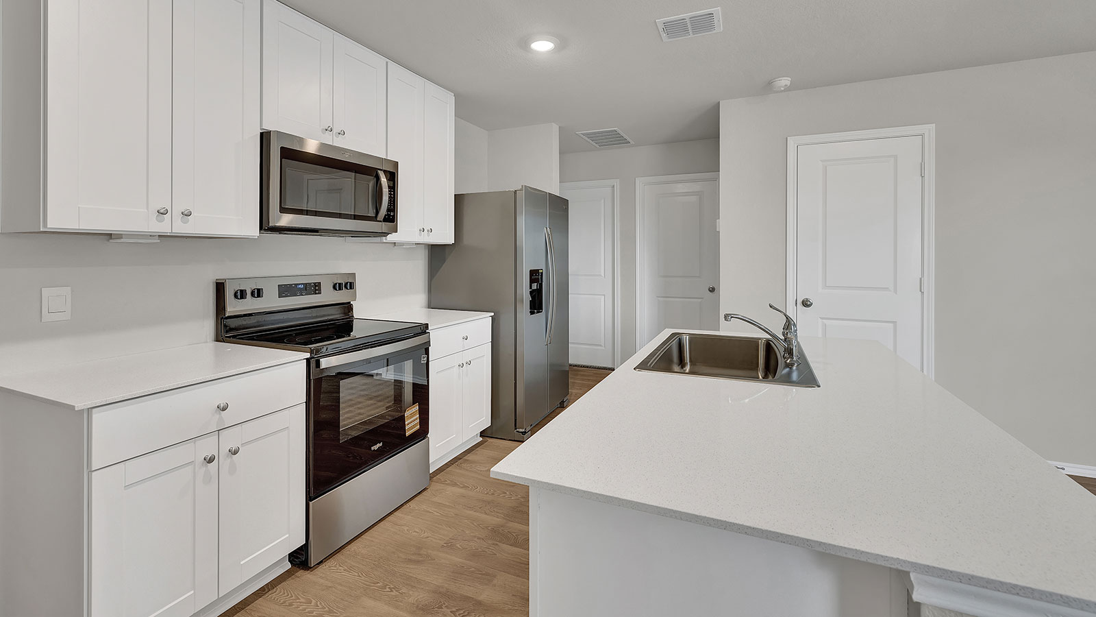 Kitchen with kitchen island and white cabinets.