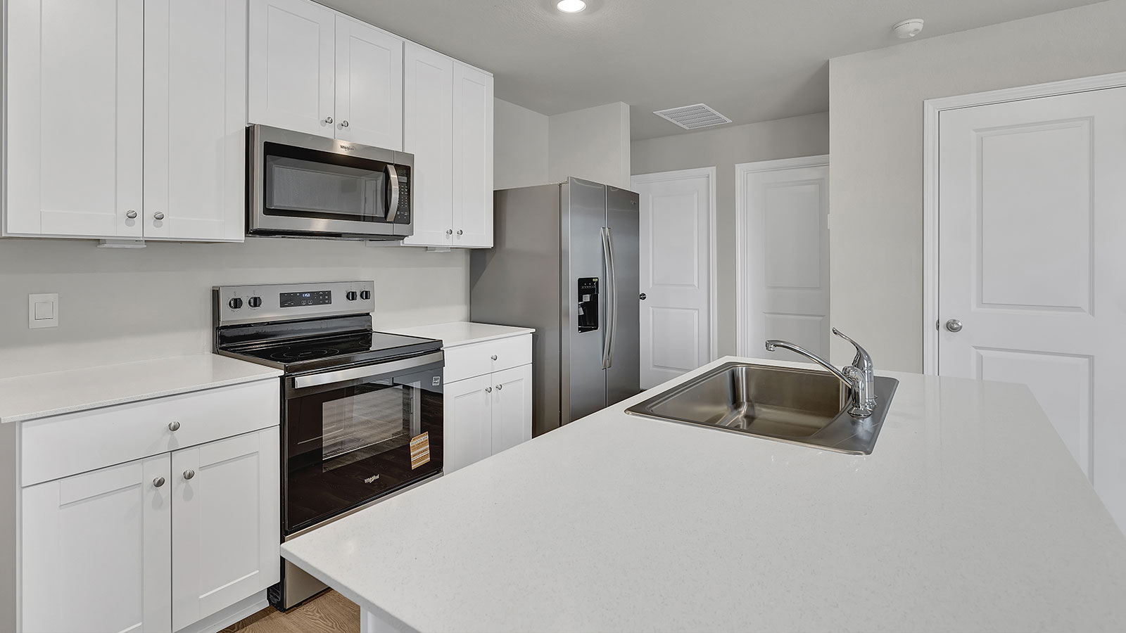 Kitchen with kitchen island and quartz countertops.