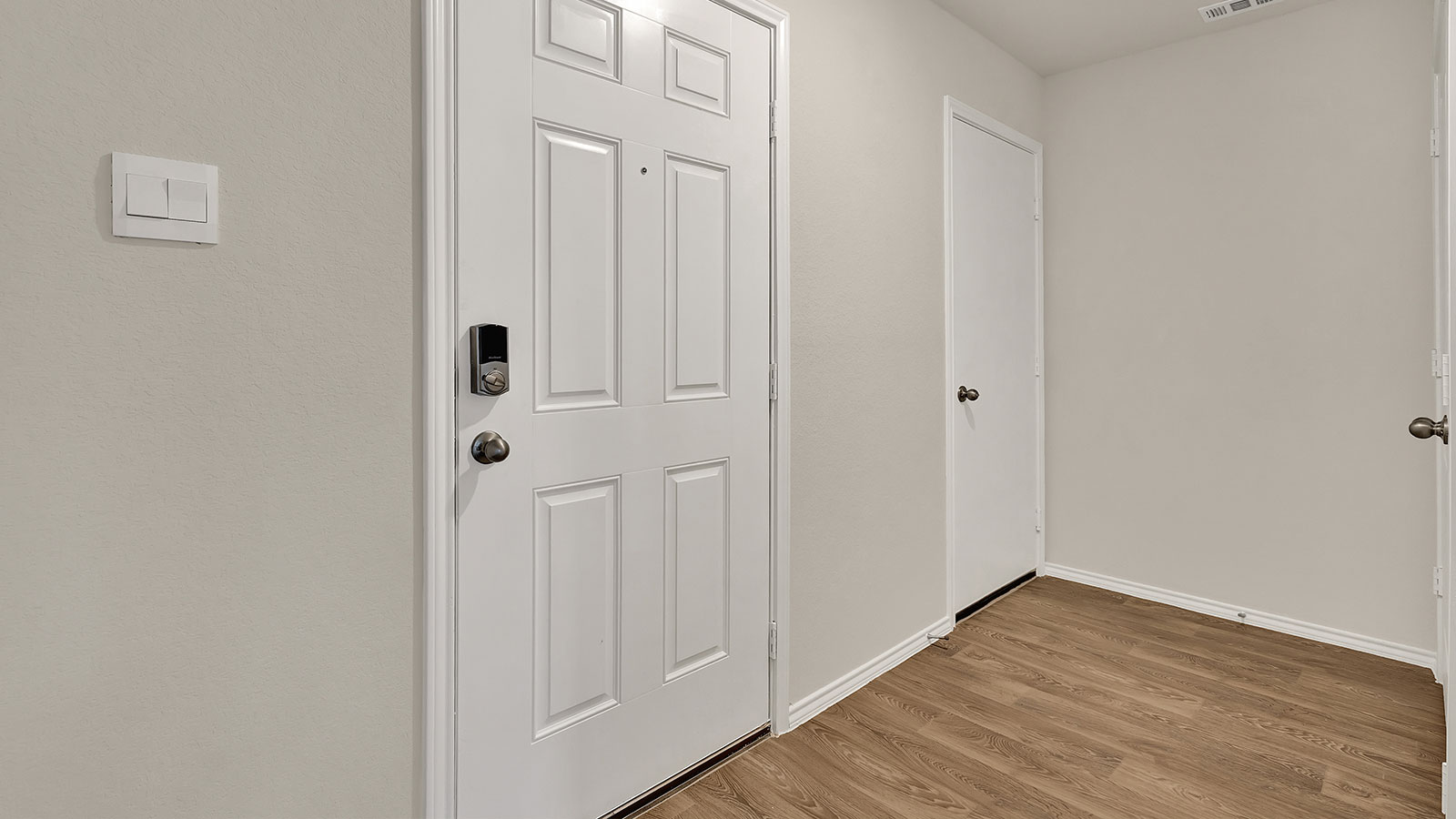 Entry hallway leading to the kitchen with kitchen island.