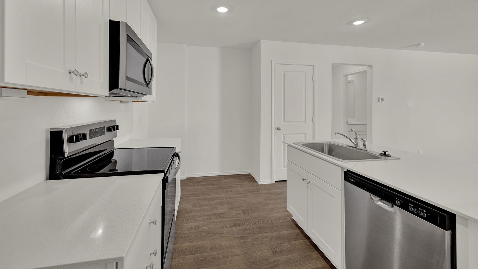 Kitchen with kitchen island and quartz countertops.