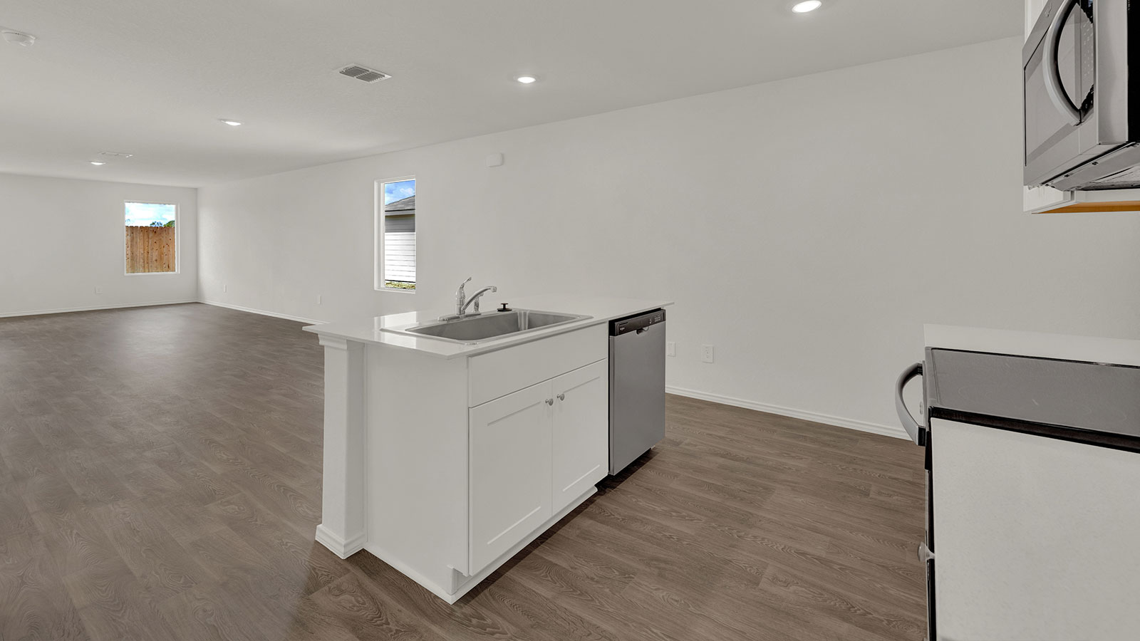 Kitchen with quartz countertops and stainless steel appliances.