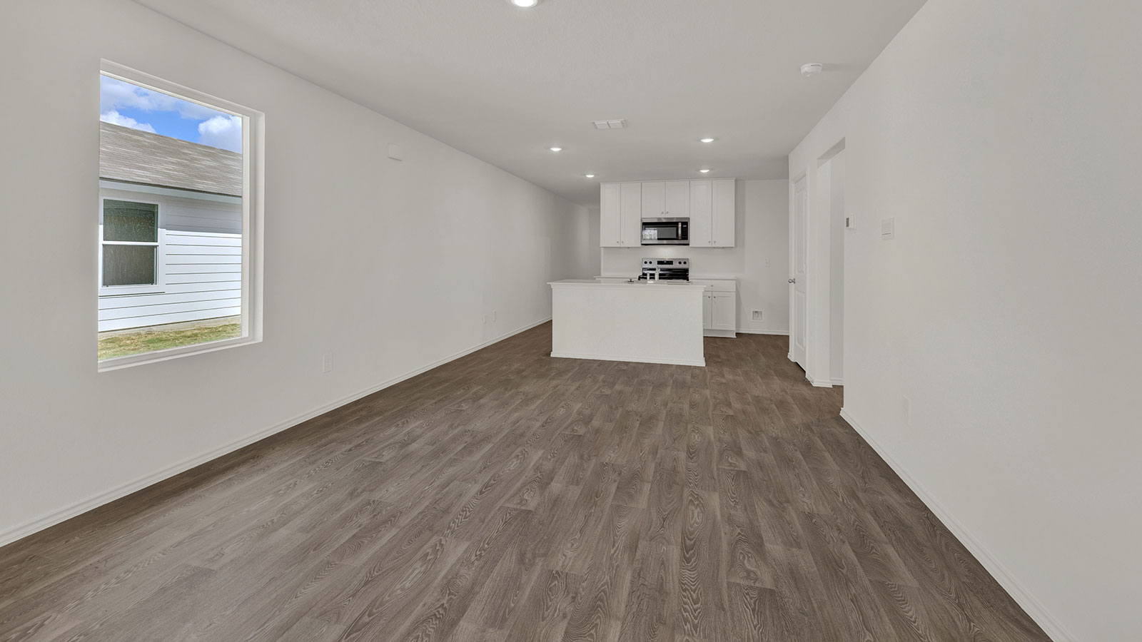 Dining room opening to the kitchen with kitchen island.