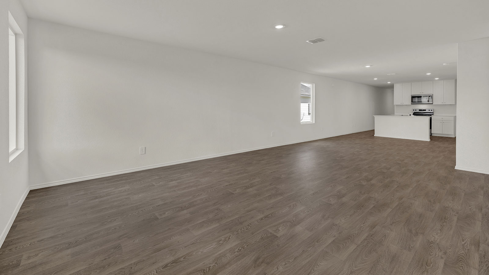 Living room opening to the dining room and kitchen.