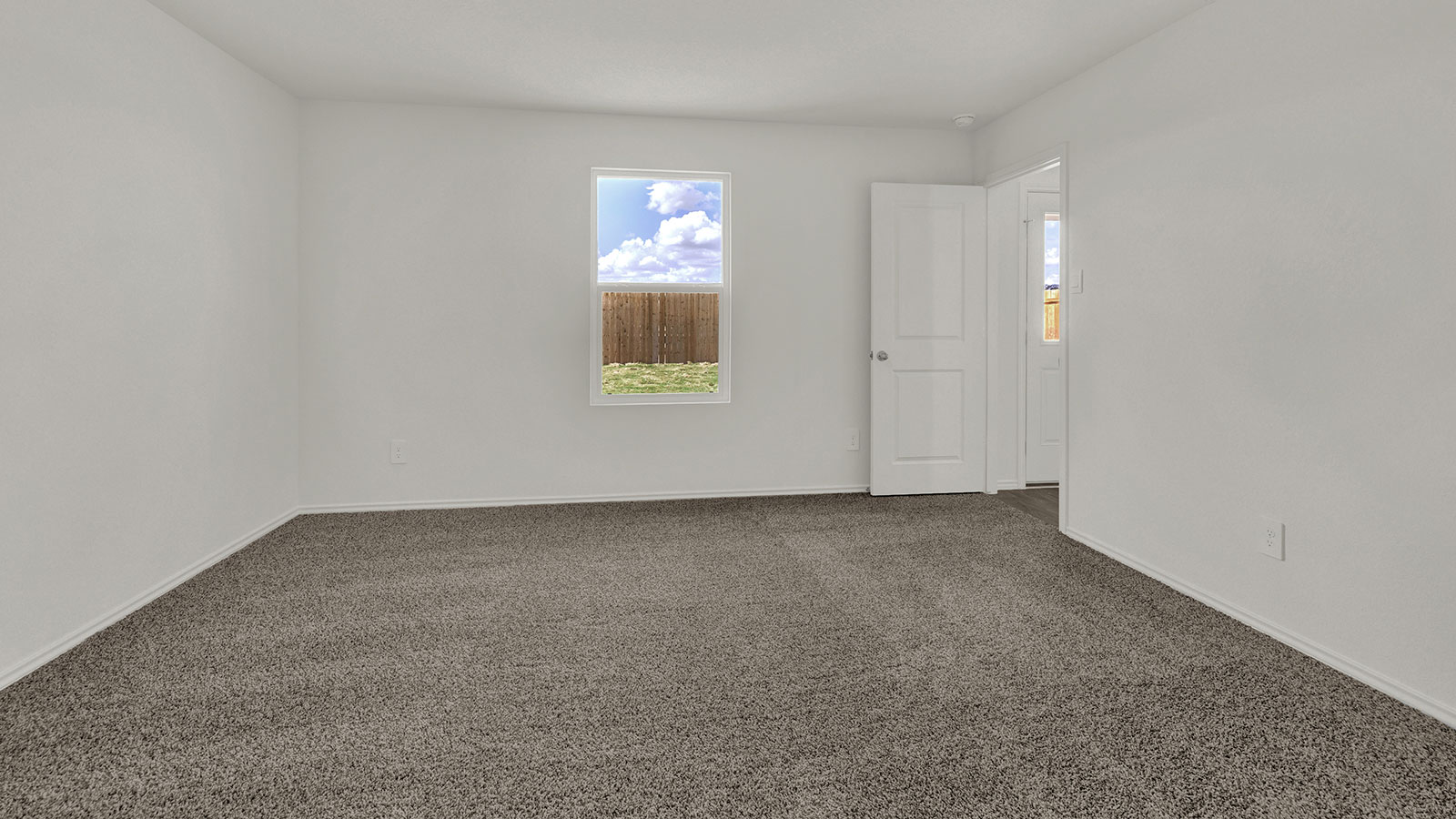 Main bedroom with carpeting and one window.