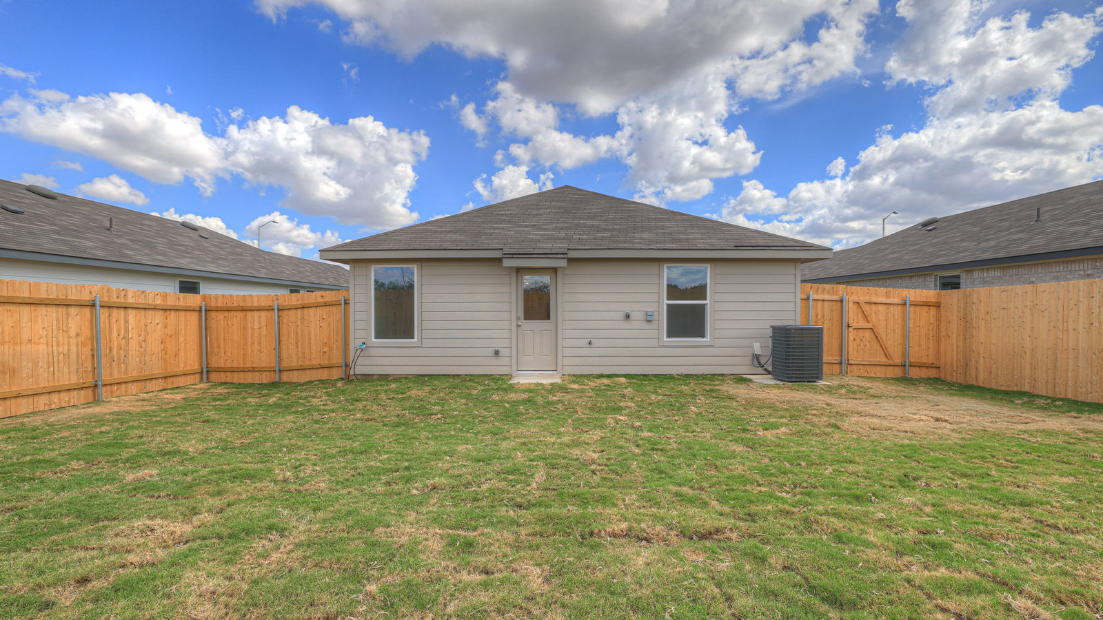 Backyard with sod and privacy fence.