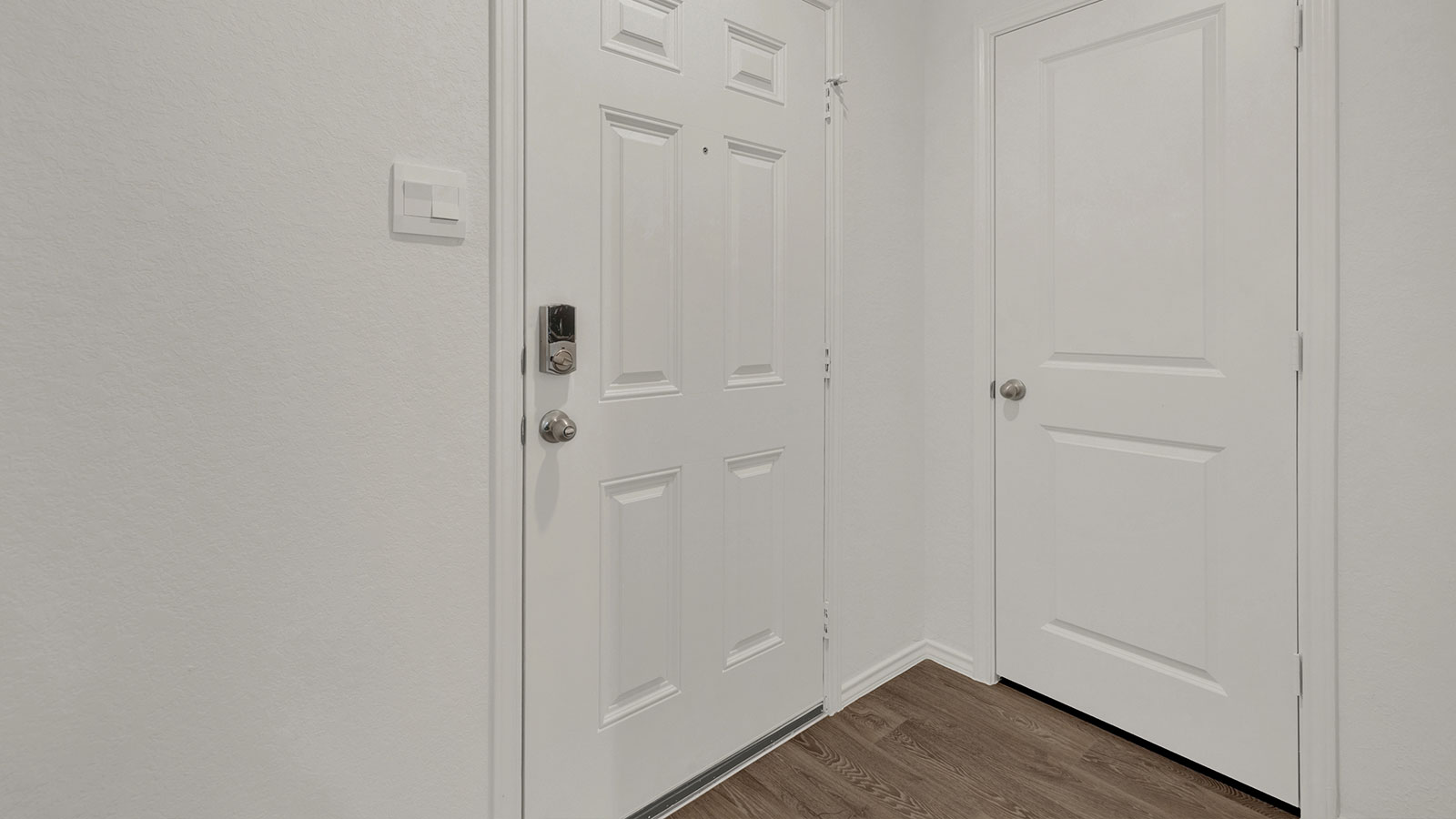 Entry hallway leading to the kitchen with kitchen island.
