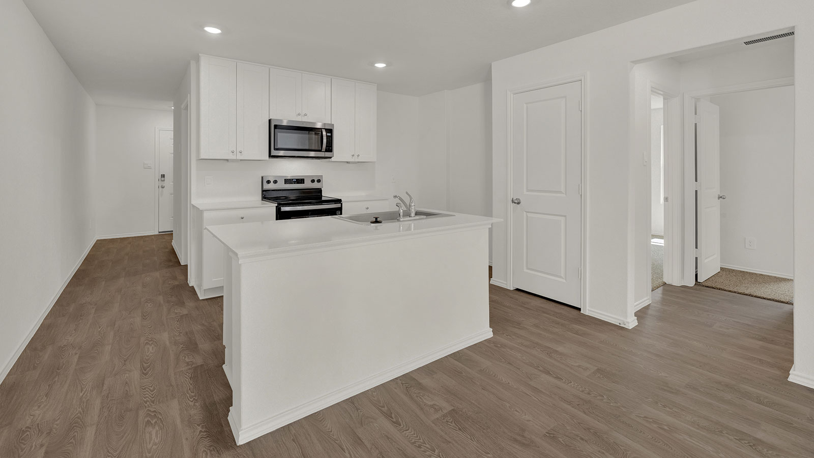 Kitchen with kitchen island and white cabinets.