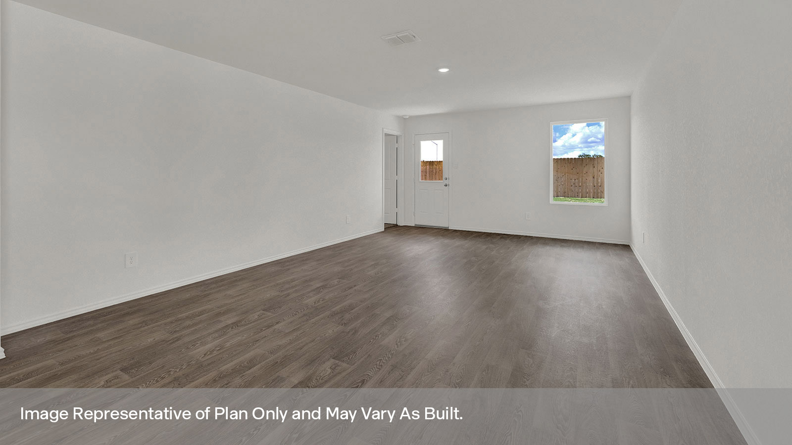 Dining room with vinyl flooring and opening to the living room.