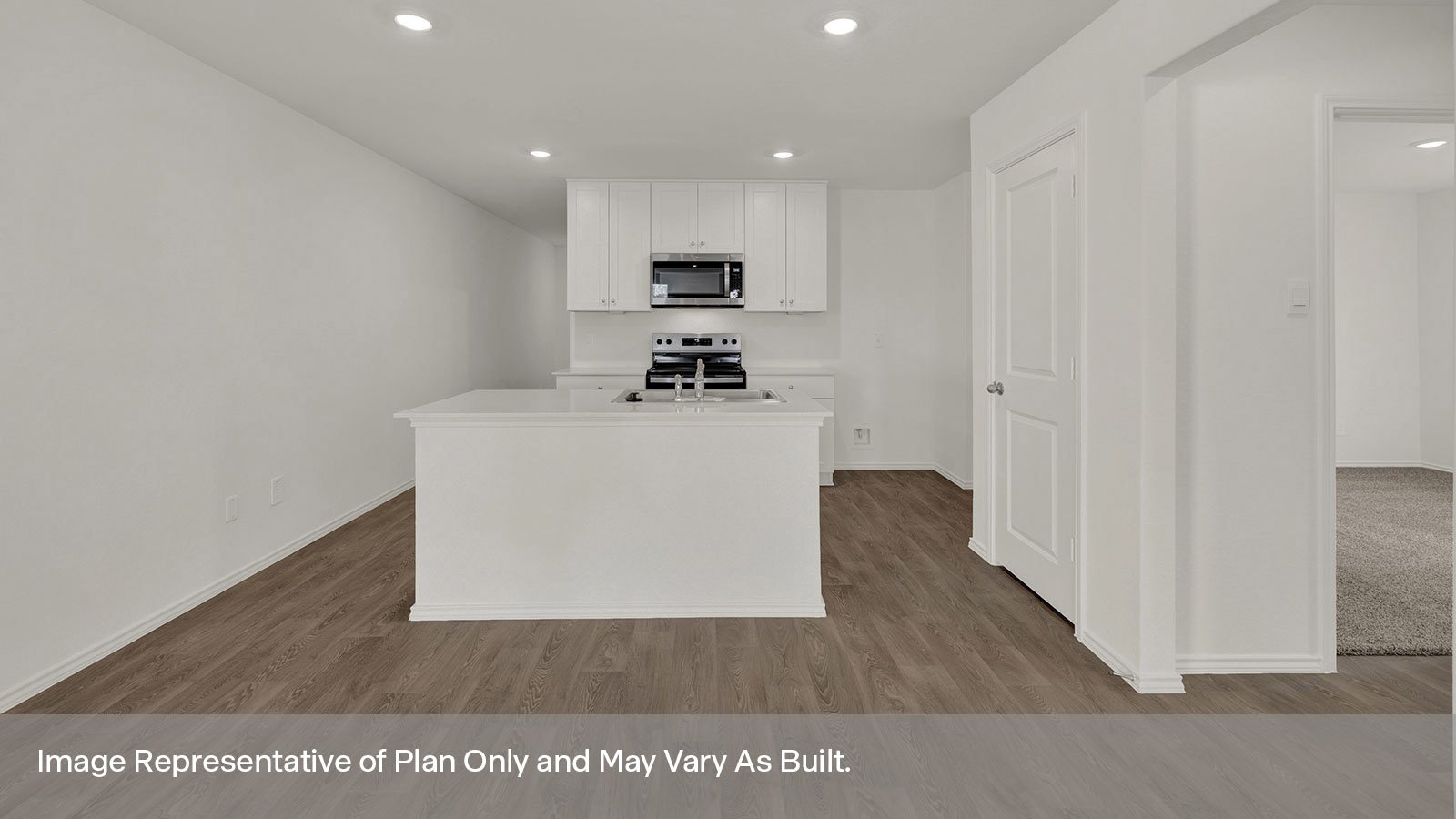 Kitchen with kitchen island and entry hallway.