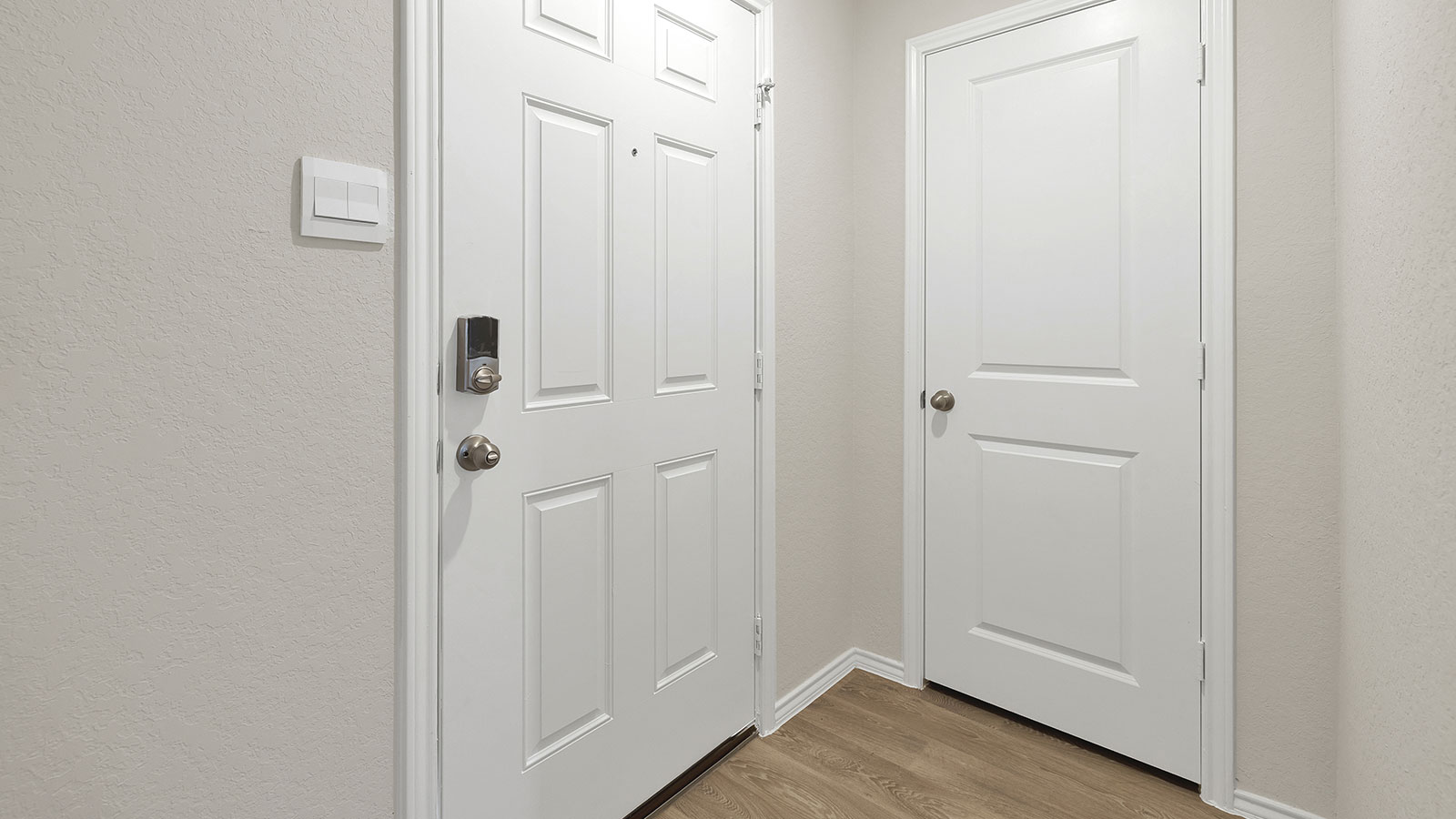 Entry hallway leading to the kitchen with kitchen island.