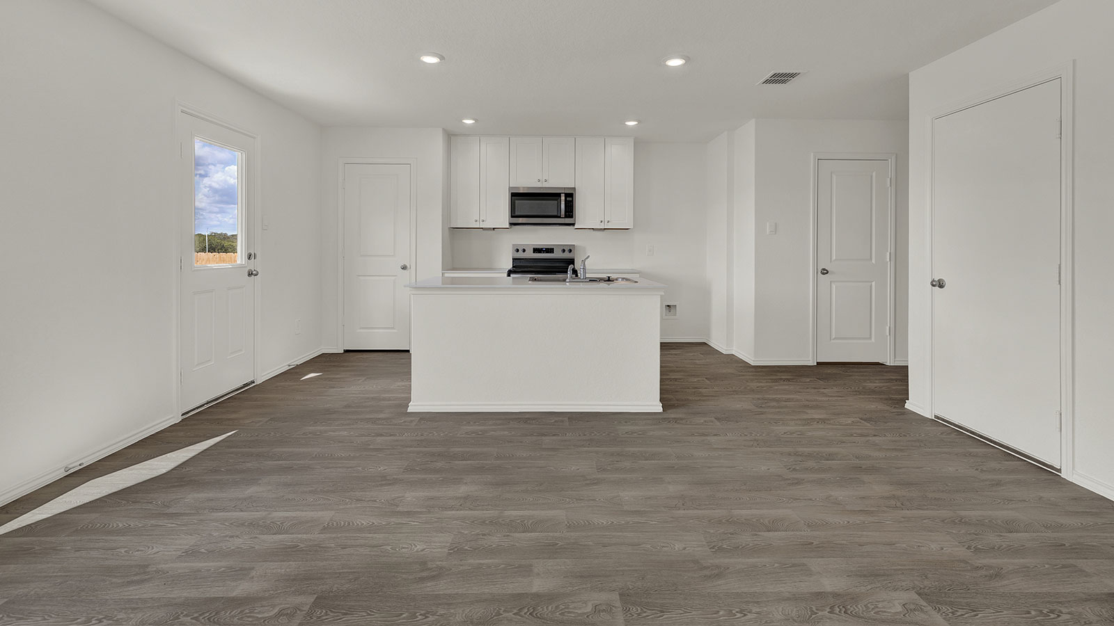 Kitchen with white cabinets and stainless steel appliances.