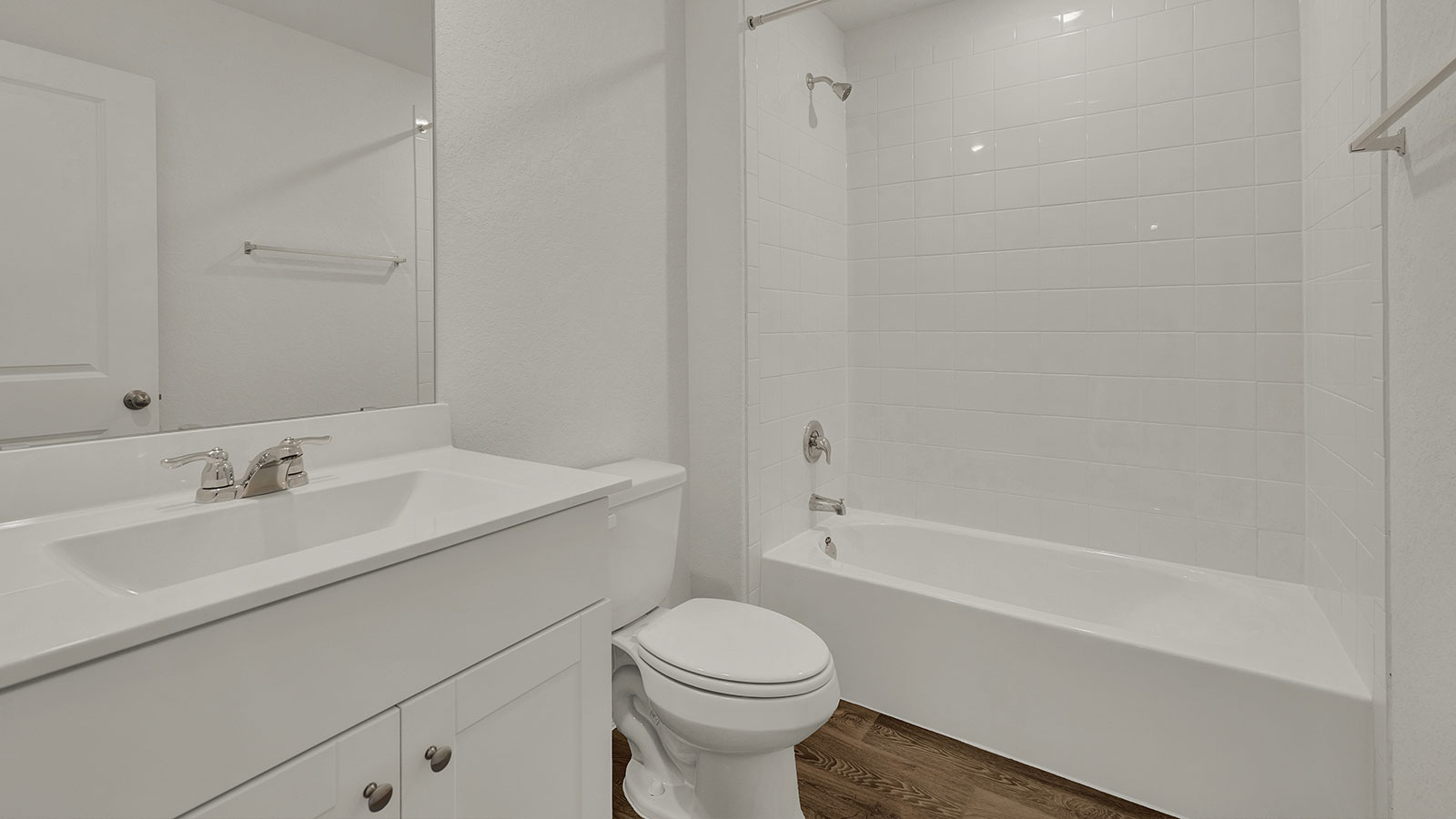 Hall bathroom with single sink, toilet, and tub.